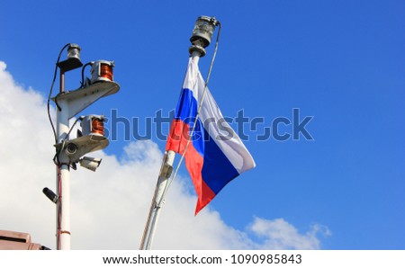 Russian Flag Isolated on Ship Deck on Blue Sky Background on Sunny Bright Day. National Flag of Russia, Country Sybol View. Flag of White, Blue and Red Color Flutters on Empty Sky Background.