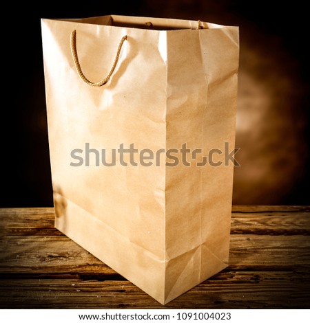 brown paper bag on wooden old table and free space foryour text. 
