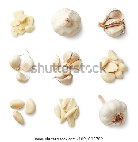 Set of fresh whole and sliced garlics isolated on white background. Top view Royalty-Free Stock Photo #1091005709