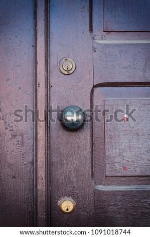 Closed Old vintage wood door with a metallic door knob