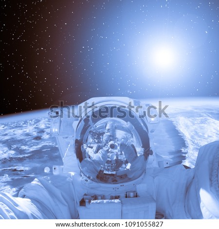 Astronaut and magnificent earth in outer space. The elements of this image furnished by NASA.