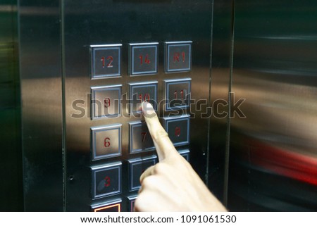 white women is pressing button of a lift 