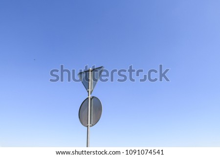 Empty road signs isolated on blue sky background
