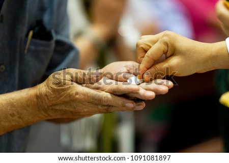 Catholic Eucharist, Eucharistic Celebration, The pastor gave the bread to those who come to join the Eucharist. That is the belief of Roman Catholics. Holy communion. -image Royalty-Free Stock Photo #1091081897