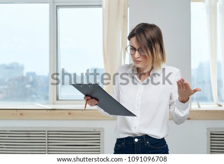 surprised woman with a folder for documents                              
