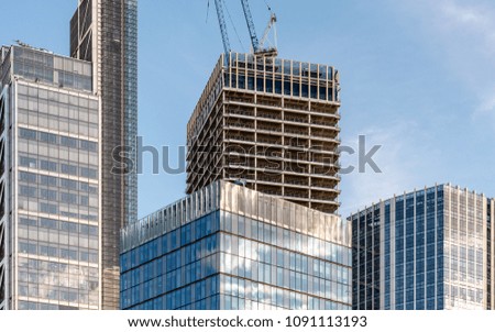 Skyscraper construction, City of London. A modern skyscraper under construction rising out of the heart of the UK capital's financial district.