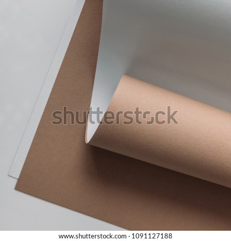white and brown paper sheets on grey background  