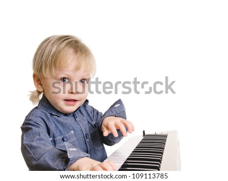 playing and singing little boy on black background