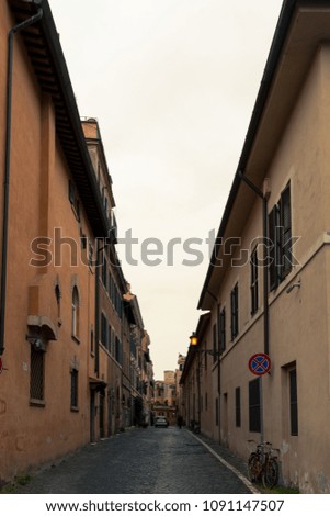 ROME, ITALY, MARCH 22, 2016: Vertical picture of narrow streets with colorful buildings in Rome, Italy