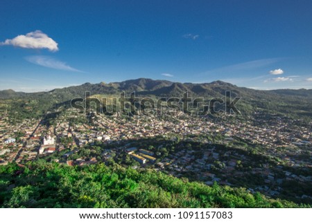 beautiful city view with a big forest around and a beautiful blue sky
