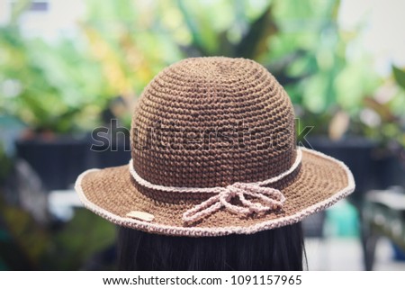 Handmade brown crochet hat on female head.