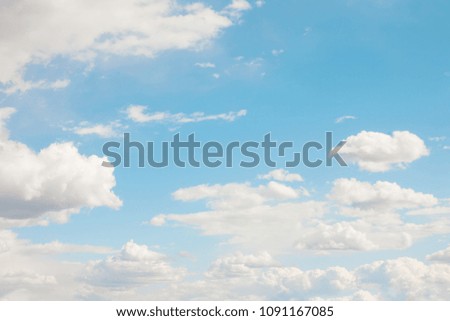 Soft Blue sky in the fluffy white clouds on a Sunny summer day. Nature cloudscape background, texture for Design. Horizontal Wallpaper With Copy Space. Beautiful Web banner for website