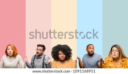 Cool group of people, woman and man doubt expression, confuse and wonder concept, uncertain future shrugging shoulders Royalty-Free Stock Photo #1091168951