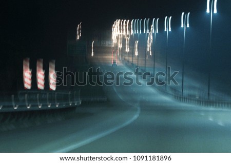 Abstract tones. Grain. Blurred. Night road and low speed shutter light at highway