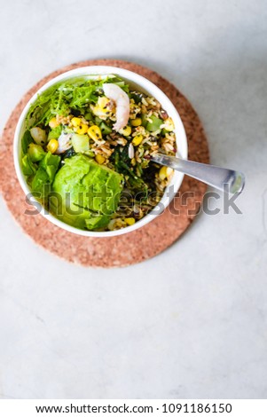 Take away salad in disposable white paper bowl on concrete background. Minimalism food photography concept. Flatlay, copyspace, vertical