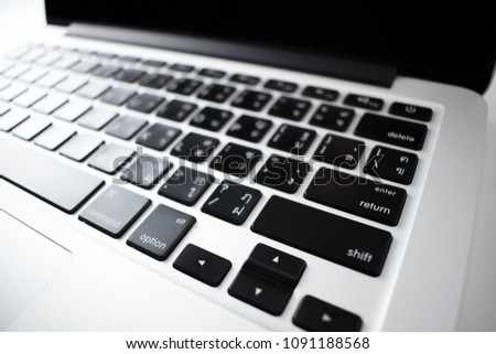 Keyboard on silver notebook.
