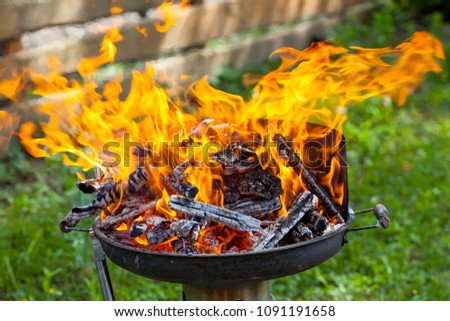 Close up picture of fire on a barbeque - preparation for cookout, grilling