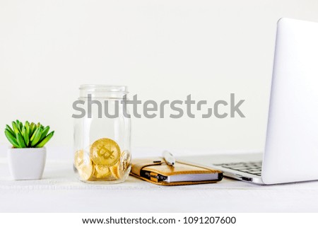 Bitcoin coin golden coin in the glass jar on wooden table ,stack of cryptocurrencies bitcoin isolated on white background,Bitcoin coin golden coin.