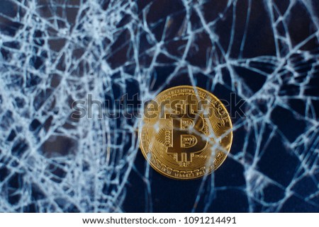 Bitcoin and cracked glass on black background. Golden Bitcoin Virtual Money Goes Down on Black Board Cryptocurrency Bubble Crash Collapse Online Money
