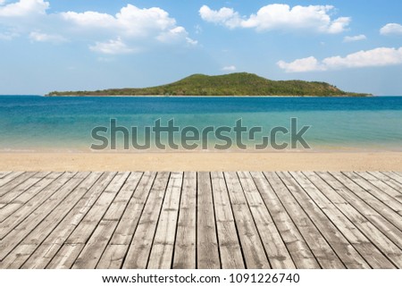 Wooden floor on beach with mountain and cloudy background. For your product placement or montage with focus to the table top in the foreground. Empty wood white shelf. shelves