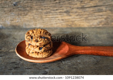 Cookies in a spoon on a vintage wooden background.