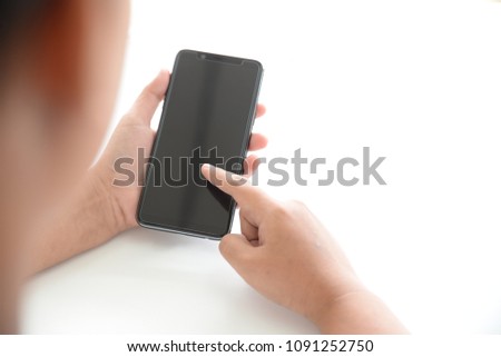 Hand using of black smartphone on white background.