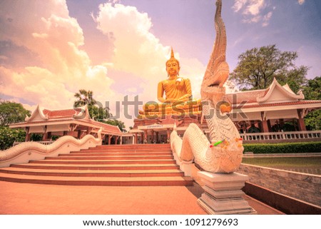 Large golden Buddha in bright sky
