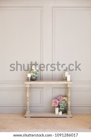 Elegant decorative fireplace full of flowers. Elegant gray room