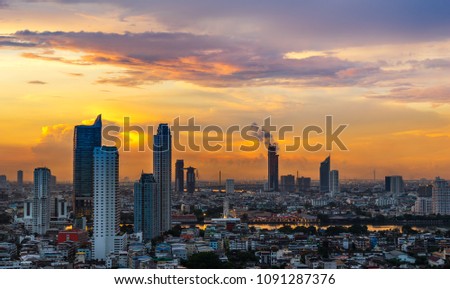 scenic of sunrise cityscape along the river and beautiful golden skyline and cloudscape 