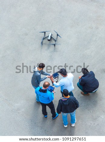 The unrecognizable person, camera operator and pilot with the controls panels teach to manage and use the drones of other new owners UAV`s drone for commercial aerial photography.