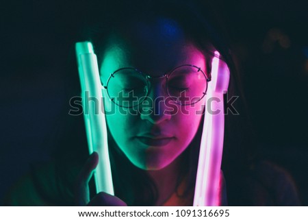 Girl with blue and pink neon lights