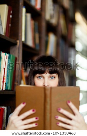 Image of young brunette with book in hand