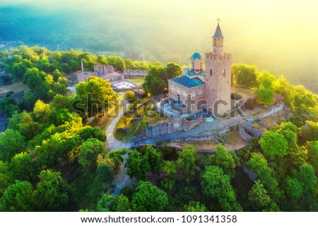 Aerial sunrise view of Tsarevets Fortress in Veliko Tarnovo in a beautiful summer day, Bulgaria 2018. Royalty-Free Stock Photo #1091341358