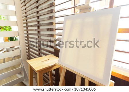 Wooden easel in the room