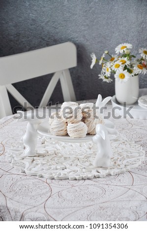 Air marshmallows on a white ceramic stand with decorative rabbits