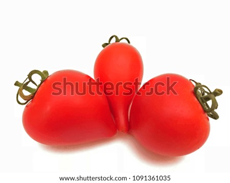 Three red tomatoes of an interesting shape on a white background