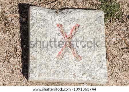 Roman numerals engraved on square granite stones