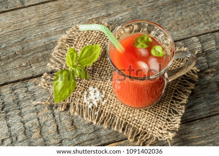 Red cocktail with tomato juice, Basil and salt, selective focus.