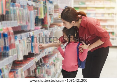 Back to school concept, Young asian mother or parent and little girl or pupil buying school supplies in store, Selective focus Royalty-Free Stock Photo #1091421200