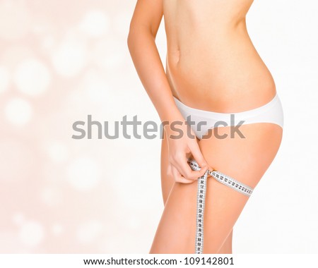 Woman taking measurements of her body, abstract background with circles and copyspace