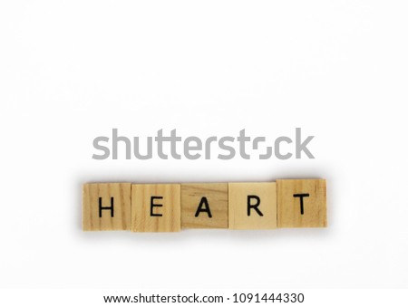 Wooden tiles spelling out the word heart on an isolated white background. Inspirational and motivational! Room for text! 