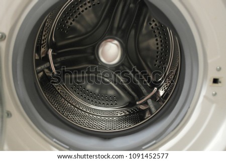 Close-up of washing machine perforated stainless steel drum intended for automatic washing of clothes
