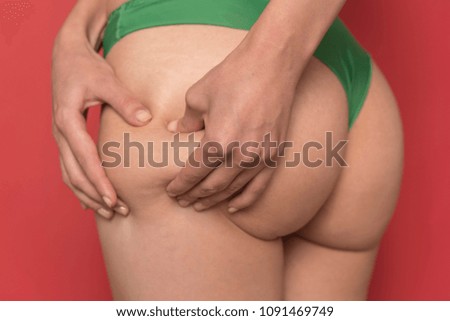 Adult female pinching skin on her butt for test