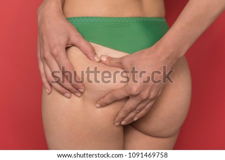 Adult female pinching skin on her butt for test