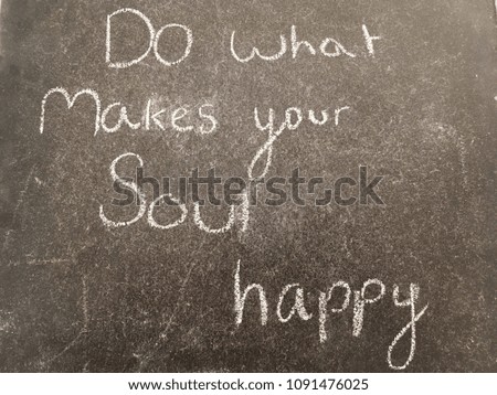 Happiness motivational quote written with chalk in chalk board