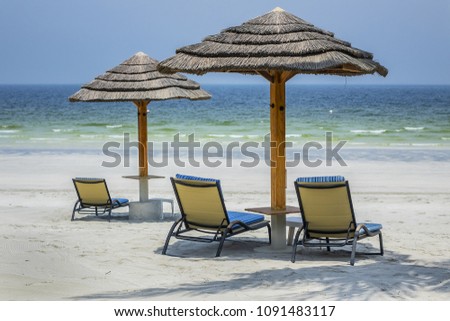 Relaxing scenery - Chaise lounge and Beach umbrella on perfect white sandy beaches.