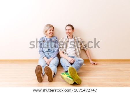 Photo of man and woman sitting on floor