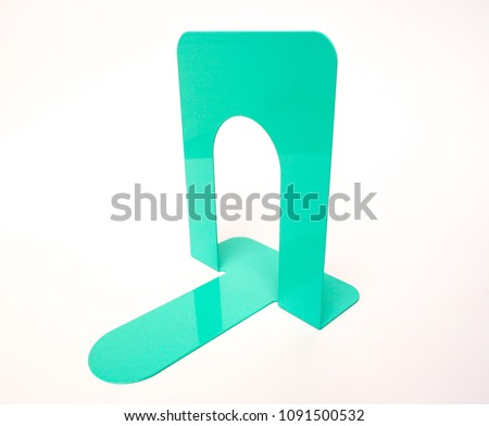 A green metal bookend. 