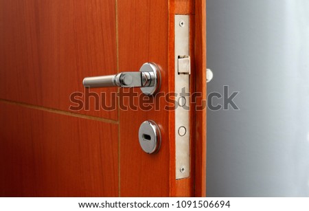 Open door of a family home. Close-up of the lock an armored door. White background.