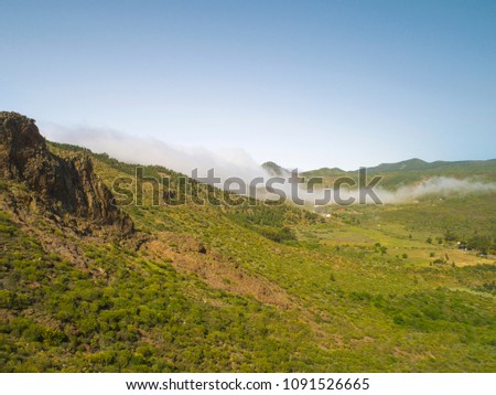 Stunning landscape mountain view. Small village in the fog. Deep canyon on a paradise island. Beautiful golden hour sunrise sunset soft light. Travel photo, postcard. Masca, Tenerife, Canary Islands